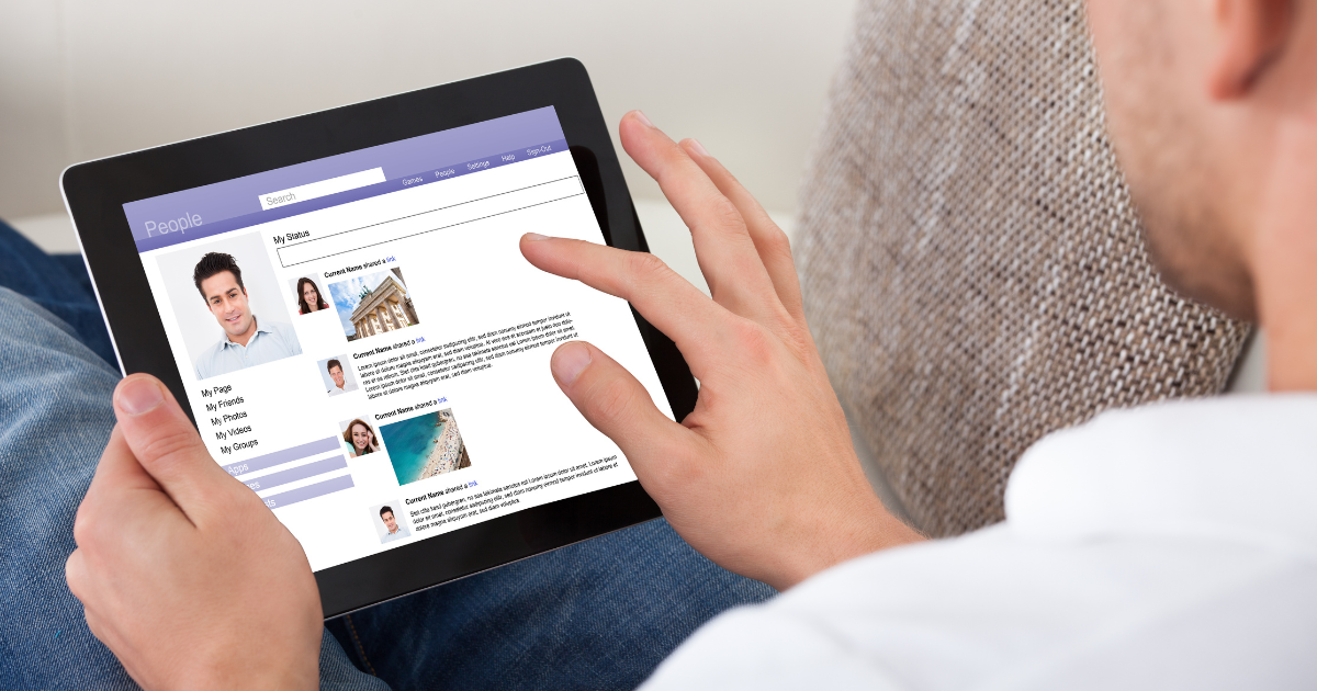 man scrolling social networking platform on a tablet